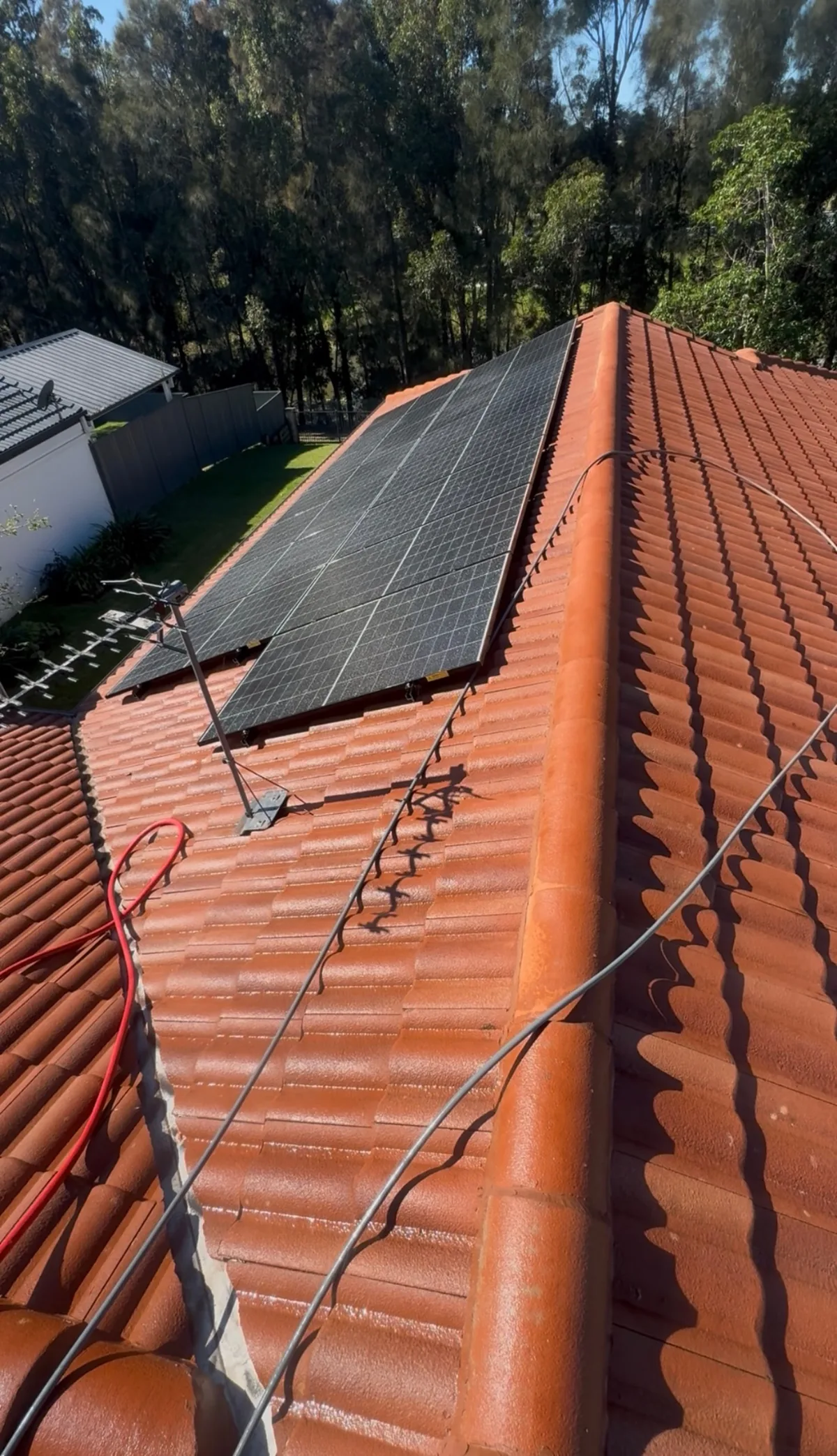 Terracotta tile roof and solar panels clean after soft wash — after